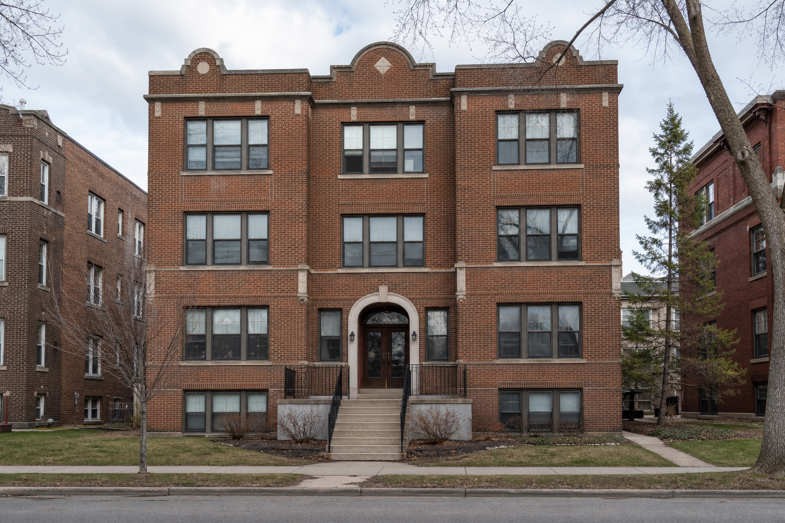A classic Saint Paul brick apartment building exterior, three stories, large windows, soft cloudy daylight.